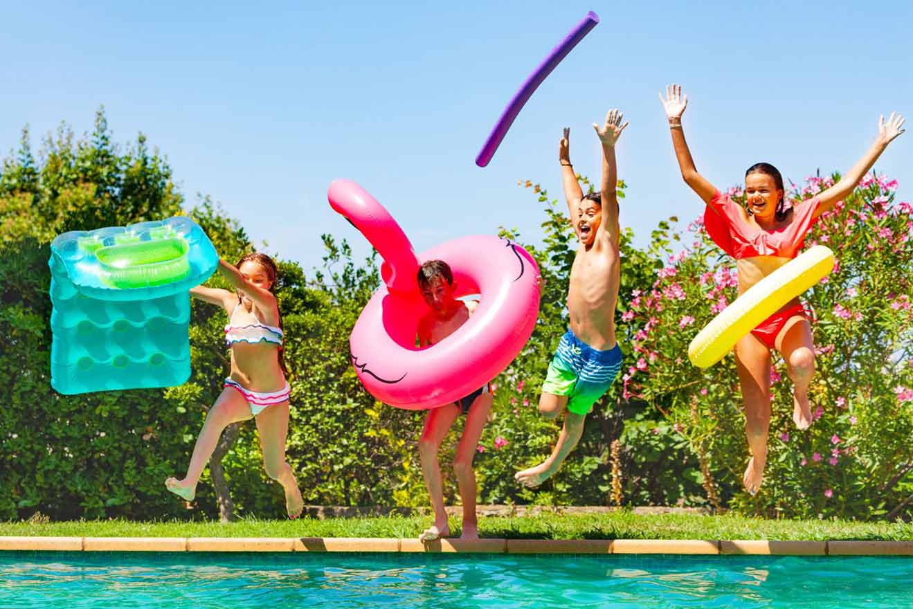 kids jumping in a swimming pool