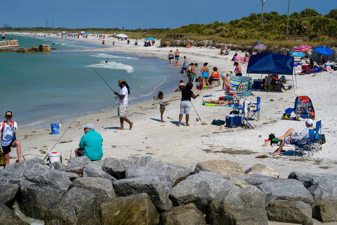 diverse crowd of fishermen, swimmers and sunbathers take to the beach