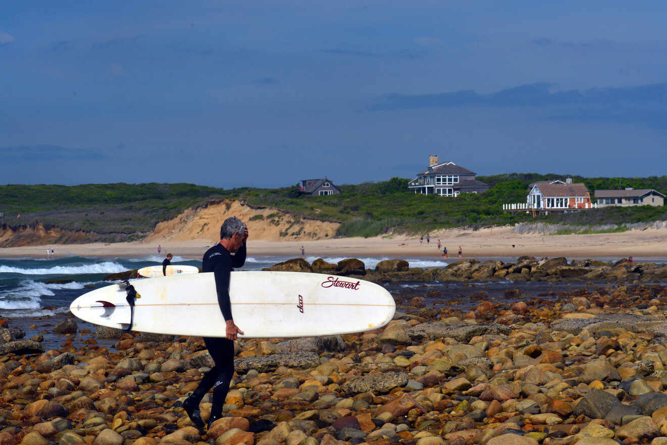 man holding a surfing board 