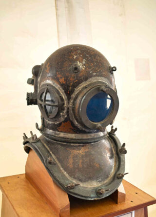 old diving helmet displayed in a museum