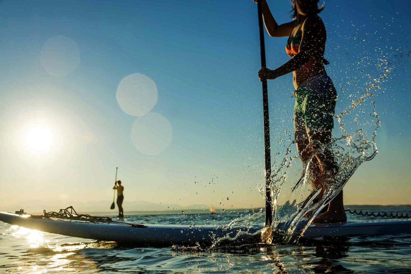 people stand-up paddleboarding 