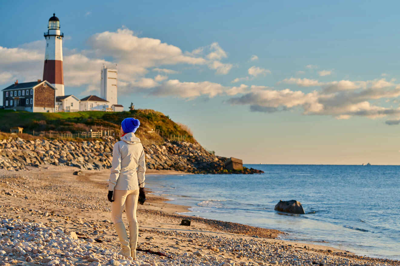 woman on the beach looking at Montauk Lighthouse