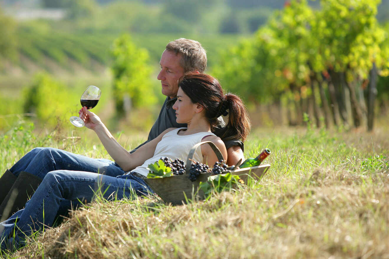 a couple enjoying a glass of wine in a vineyard