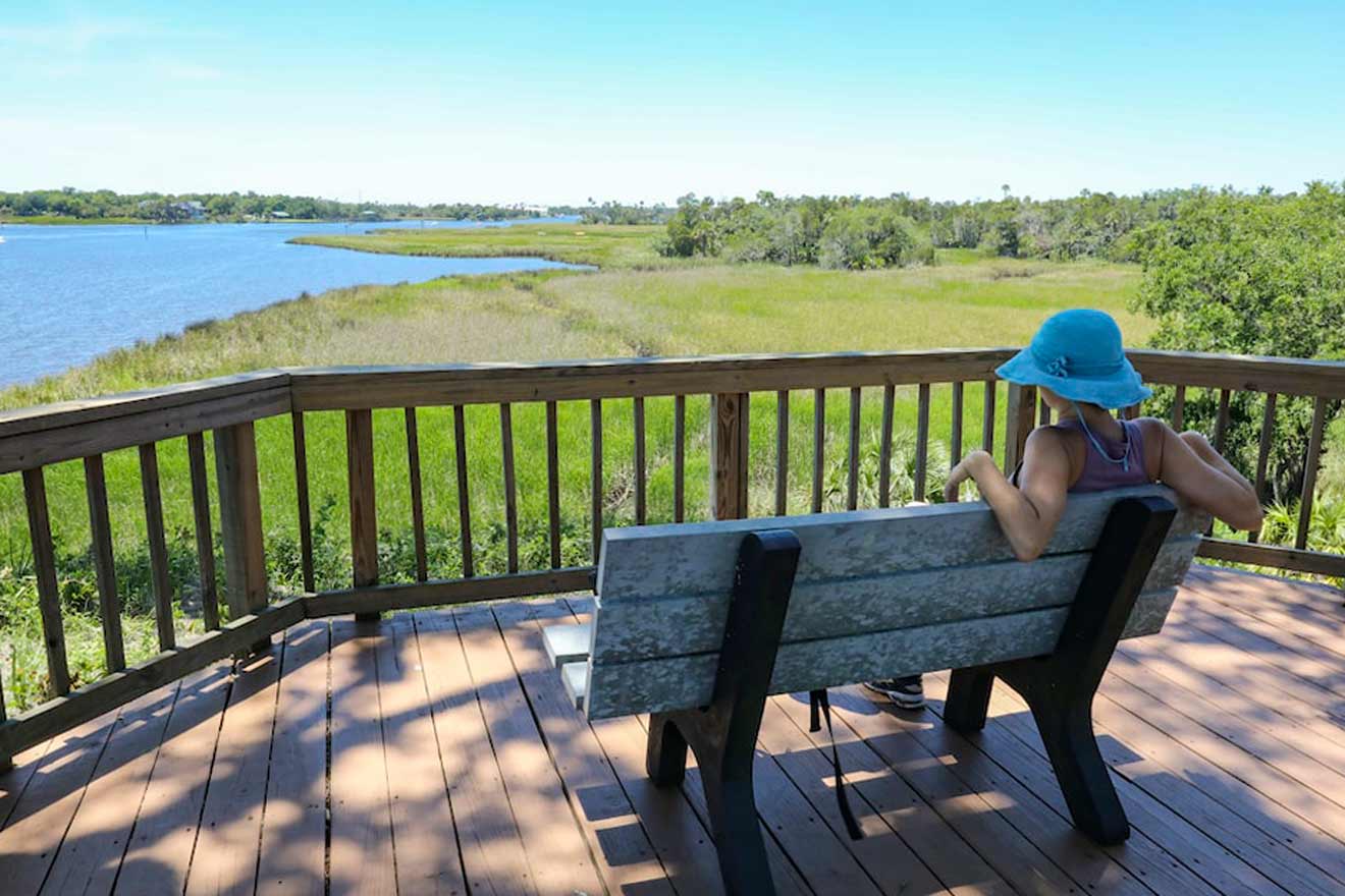 girl sits on a bench and looks at Crystal River