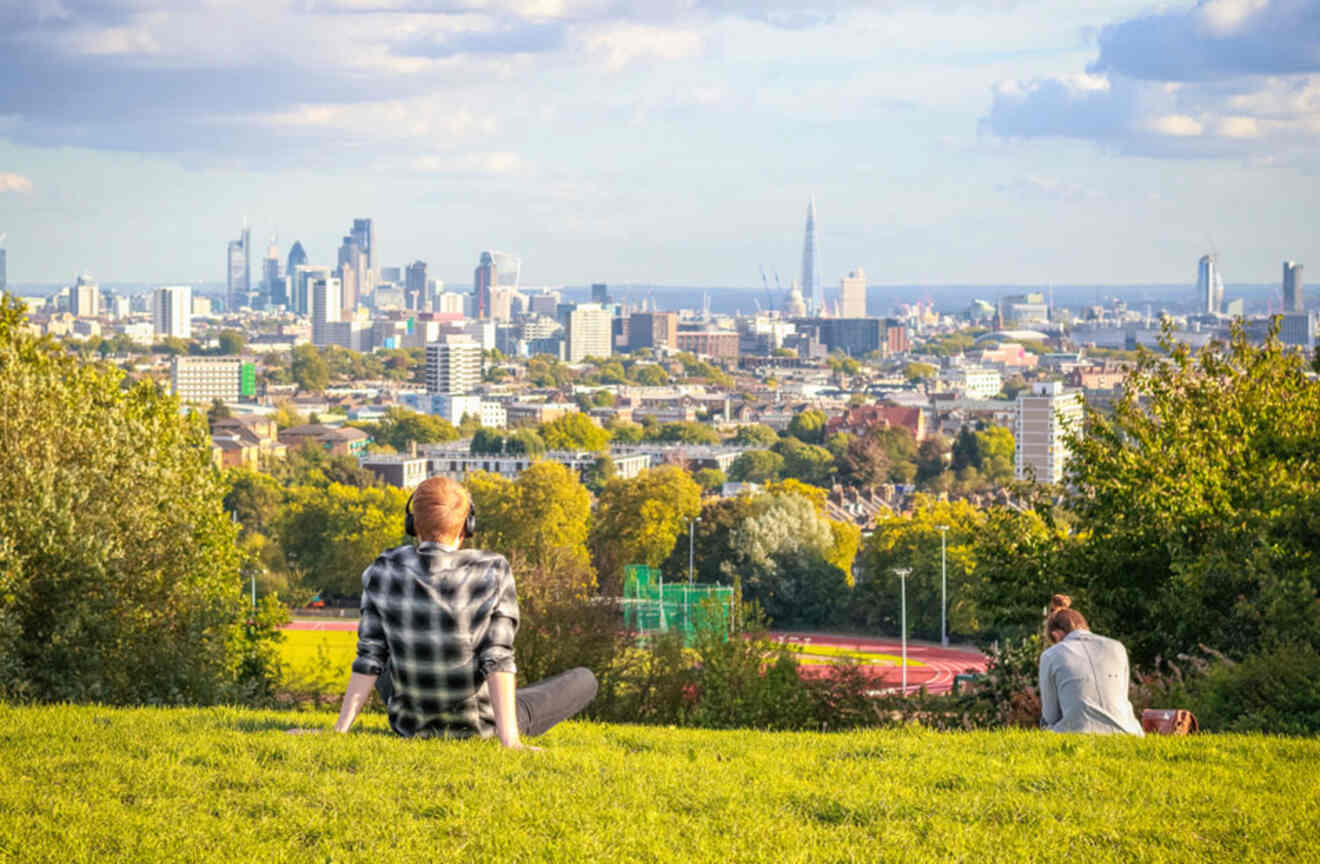 People relaxing in Hampstead Heath Park enjoying the panoramic view of London