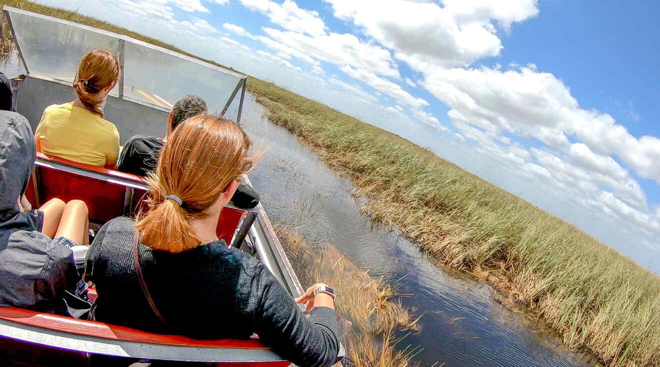 A small group of people on an airboat in the Everglades