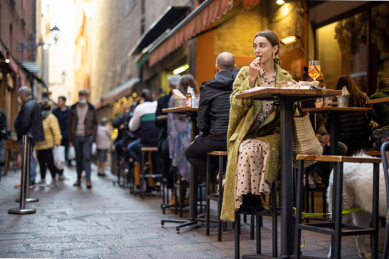 Woman enjoying food on a Bologna street