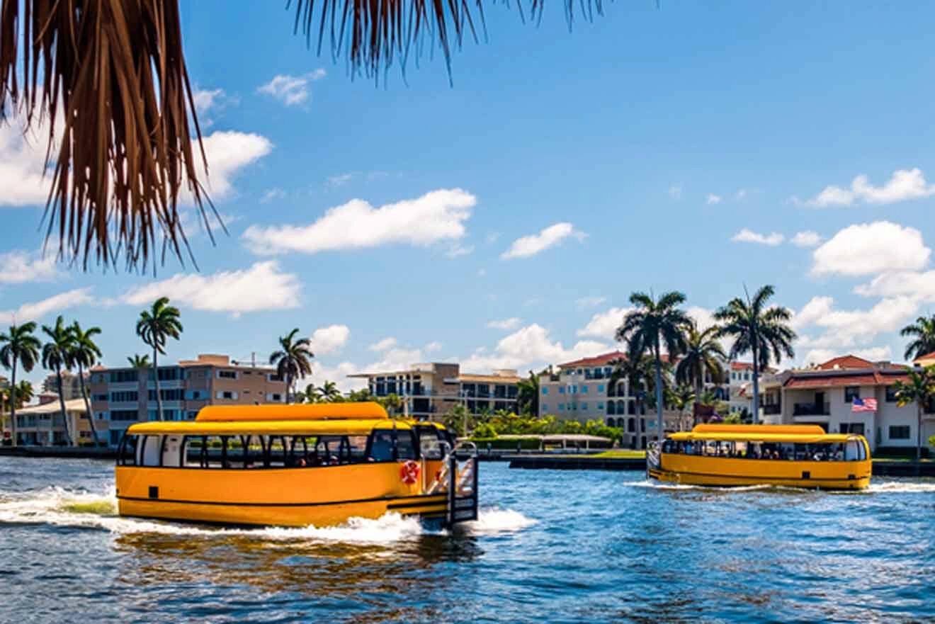 Two bright yellow water taxis glide through the blue waters of Fort Lauderdale, framed by palm trees and backed by a sunny sky and waterfront buildings