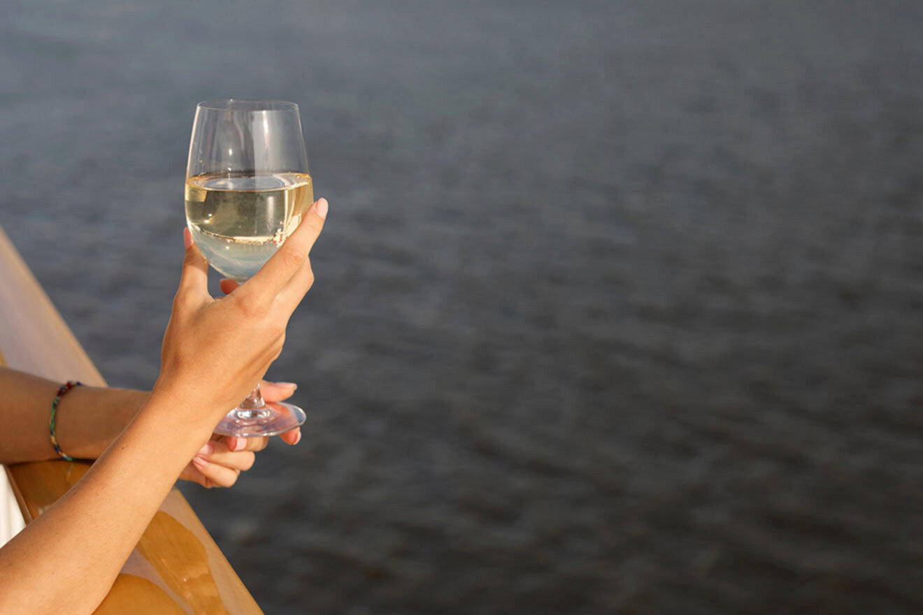 woman holding a glass of wine in a boat