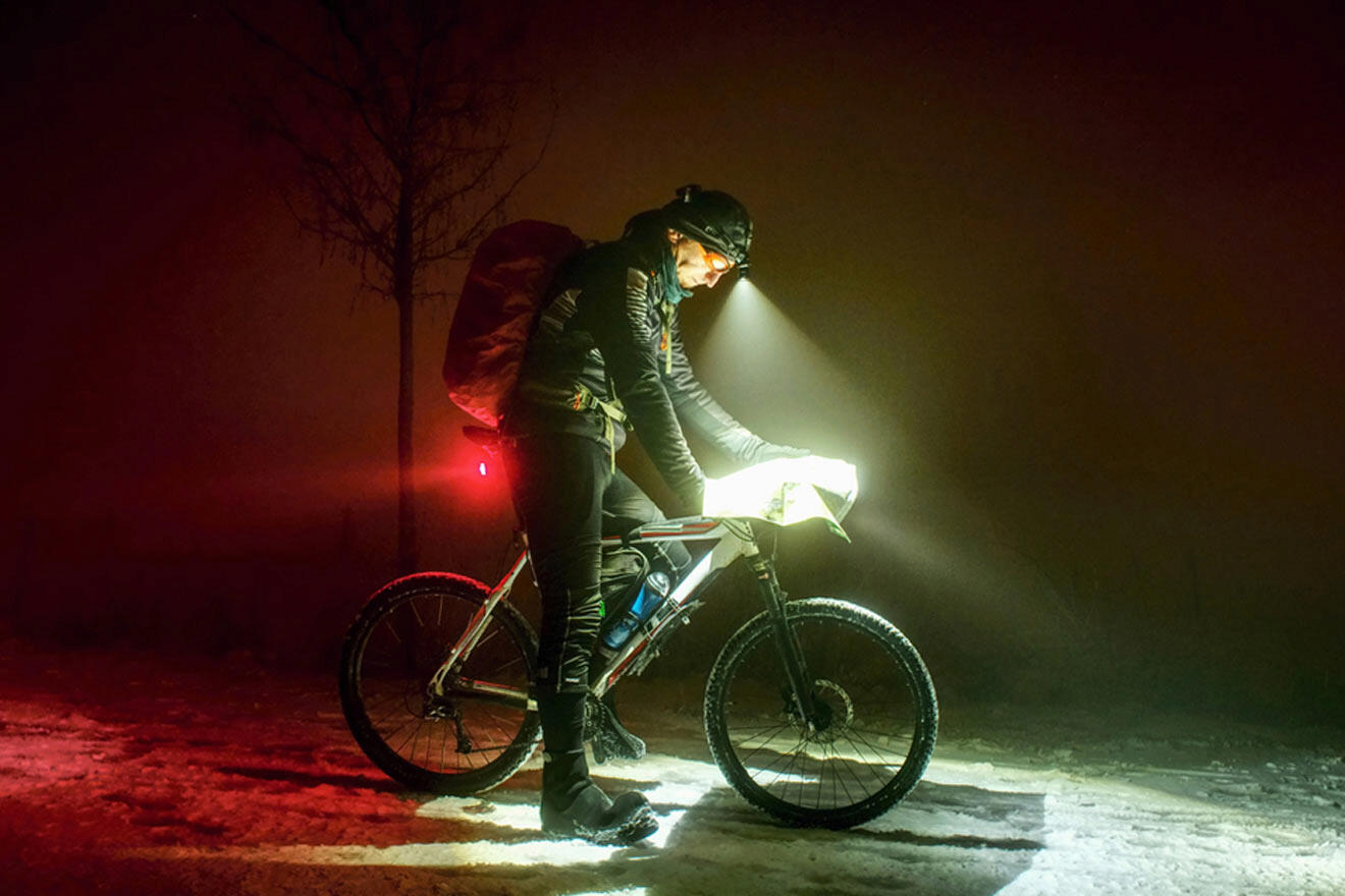 biker at night with a map