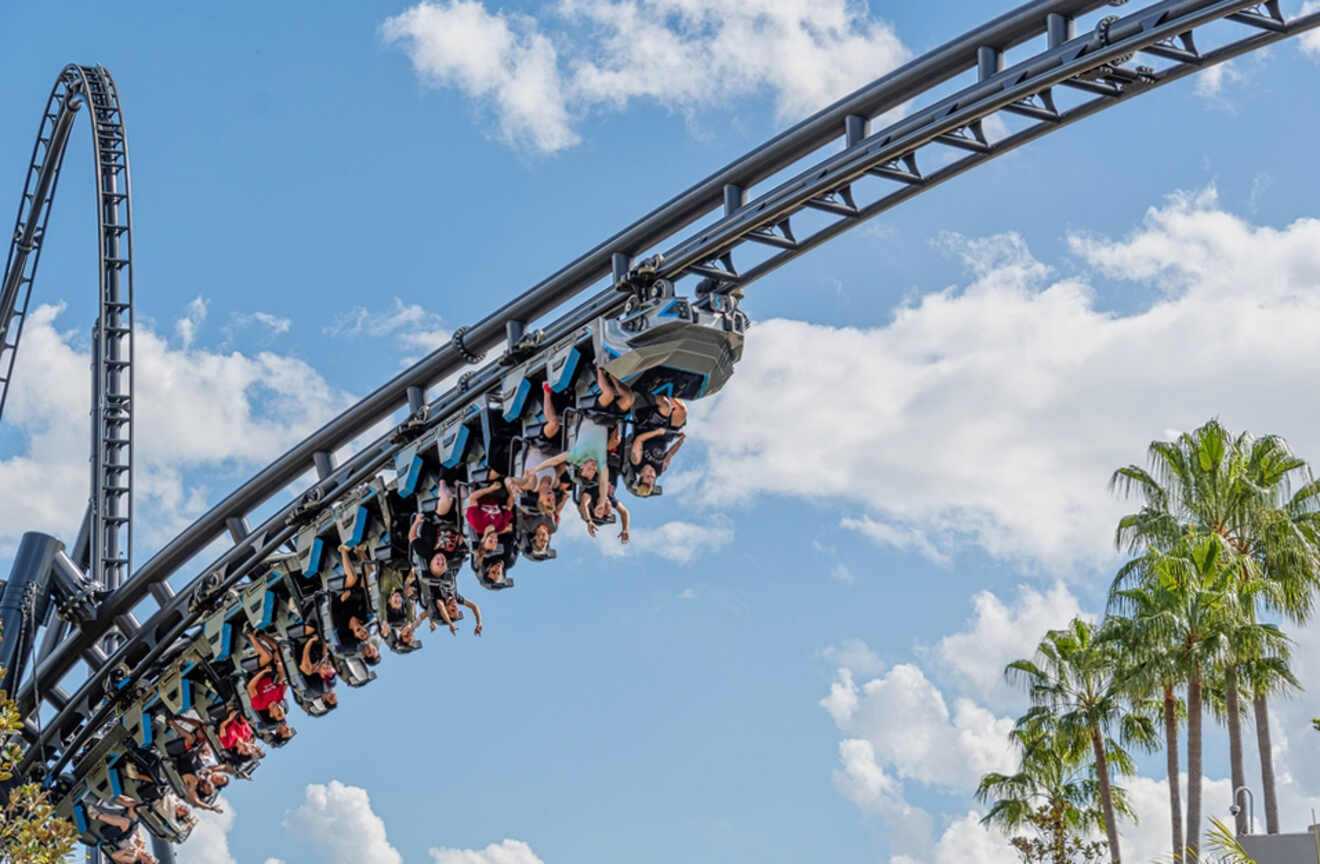 People riding upside down on the Jurassic World VelociCoaster