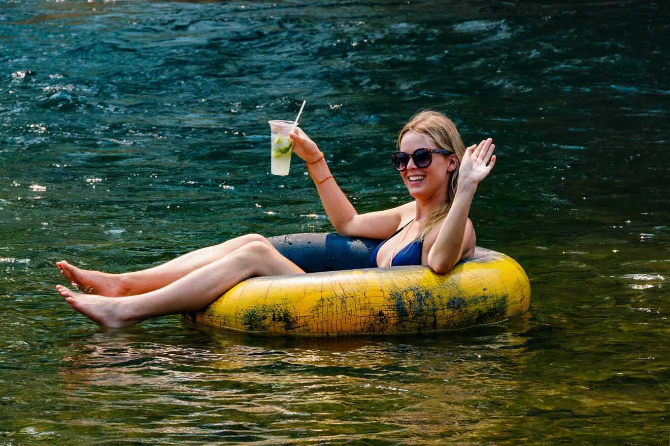woman tubing and having a drink 