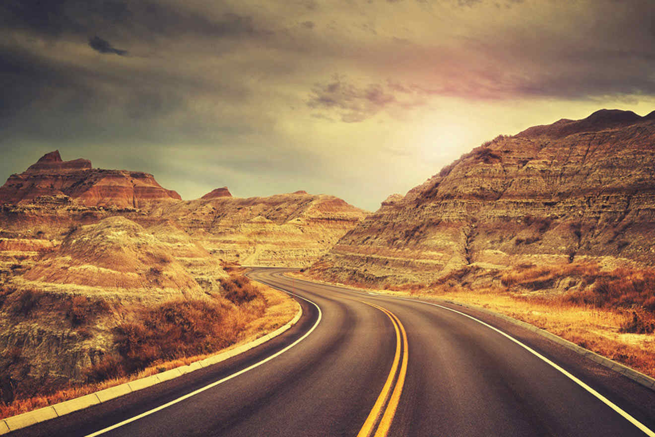 view of the road in Badlands National Park at sunset