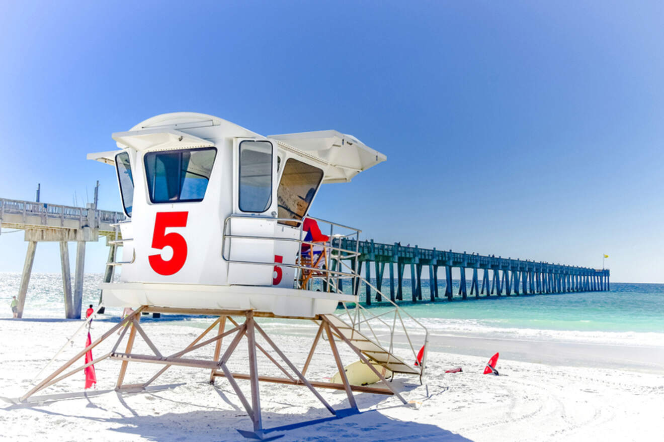 lifeguard station on a beach with a bridge in the background