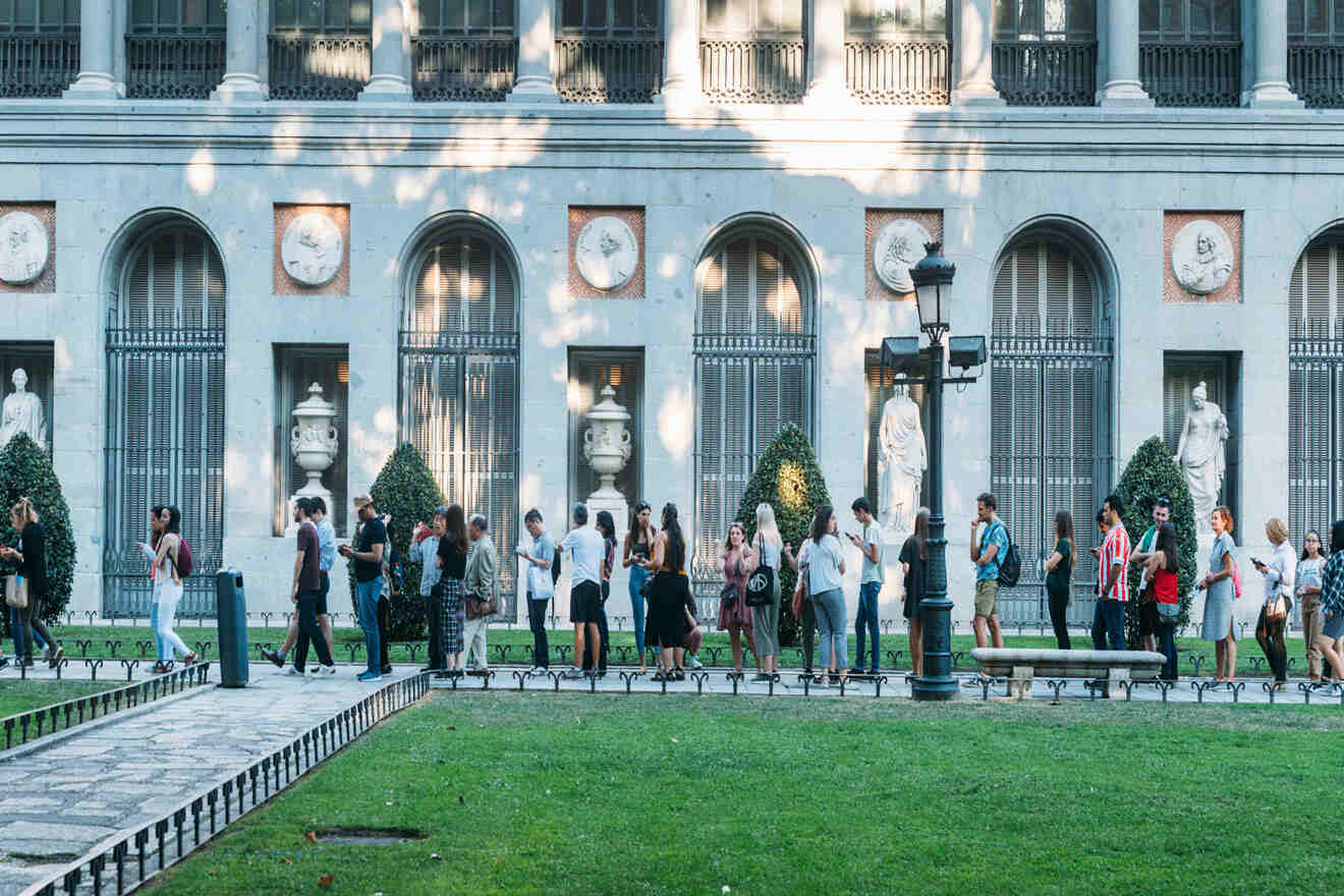 people sitting in a queue at Prado Museum entrance