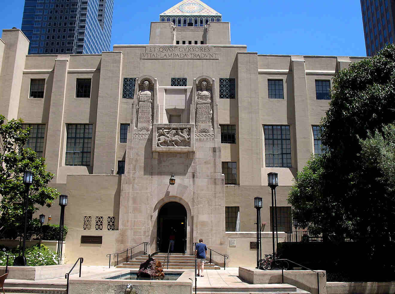 a large building with a fountain in front of it