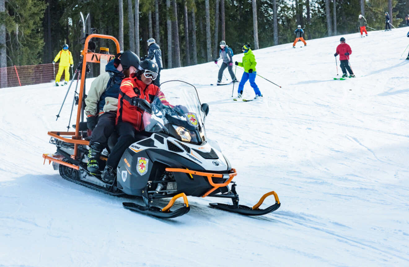 People snowmobiling on the slopes
