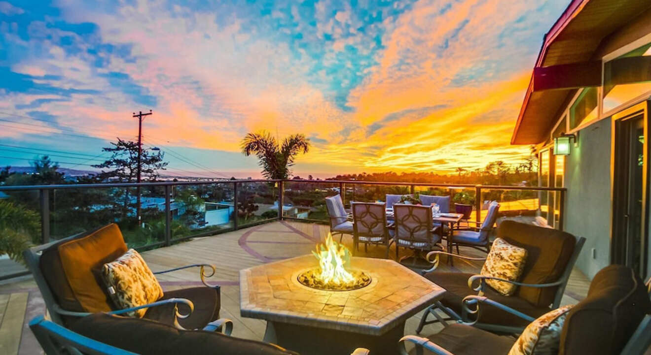View from balcony at sunset with chairs round an outdoor fireplace
