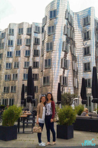 Two girls in front of a unique building in Medienhafen