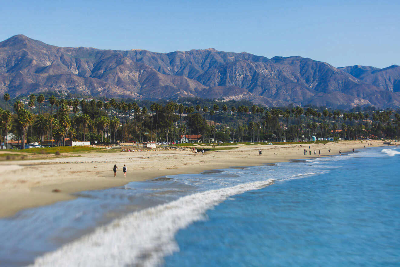 a view of a beach with mountains in the background