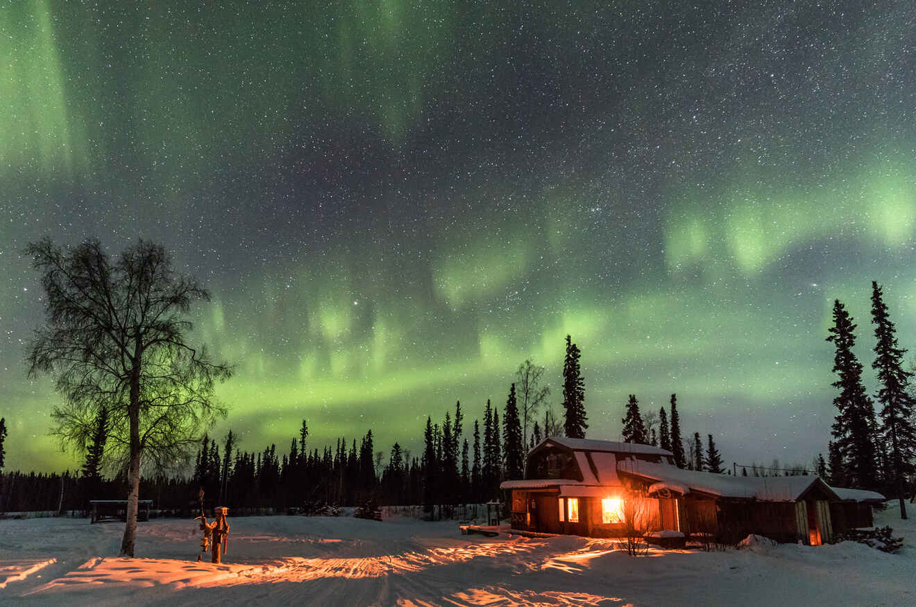 View of Northern Lights above a lodge