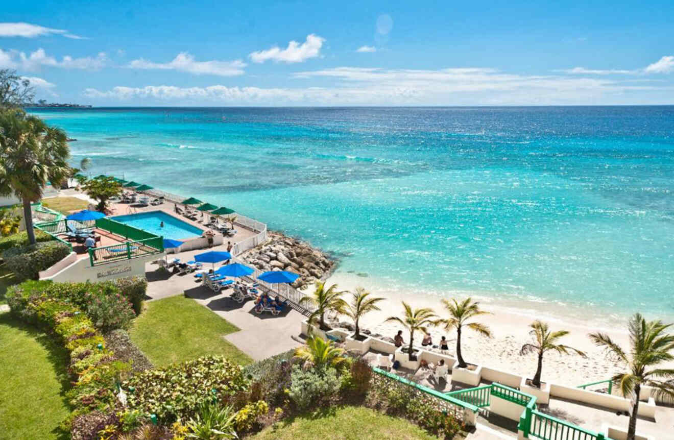 an aerial view of a beach with a swimming pool