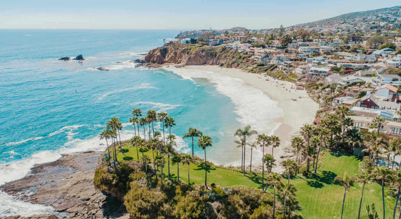 an aerial view of a beach with houses and palm trees