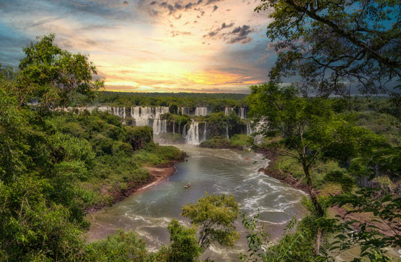 waterfalls and river flowing through a lush green forest at sunset