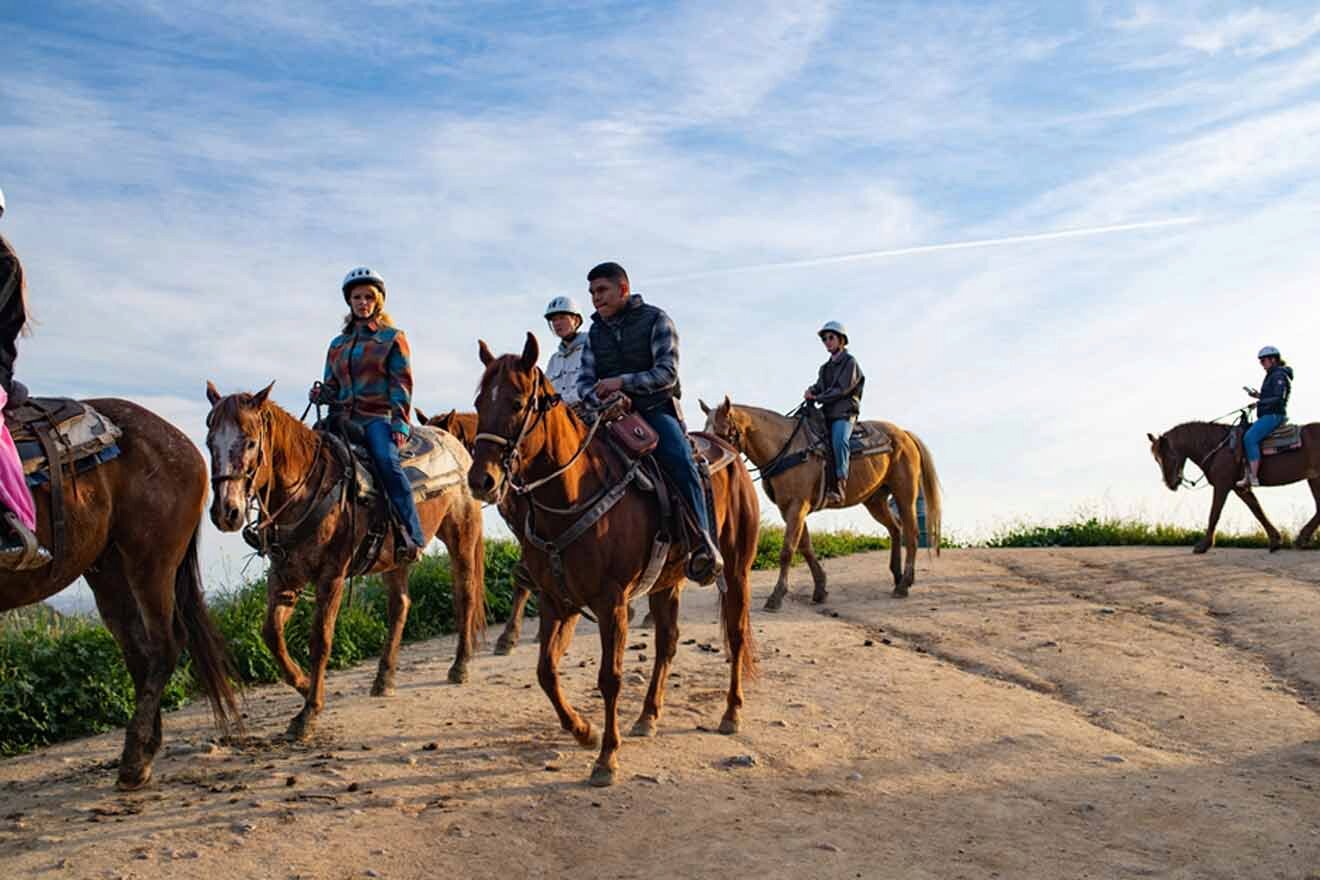 a group of people riding on the backs of horses