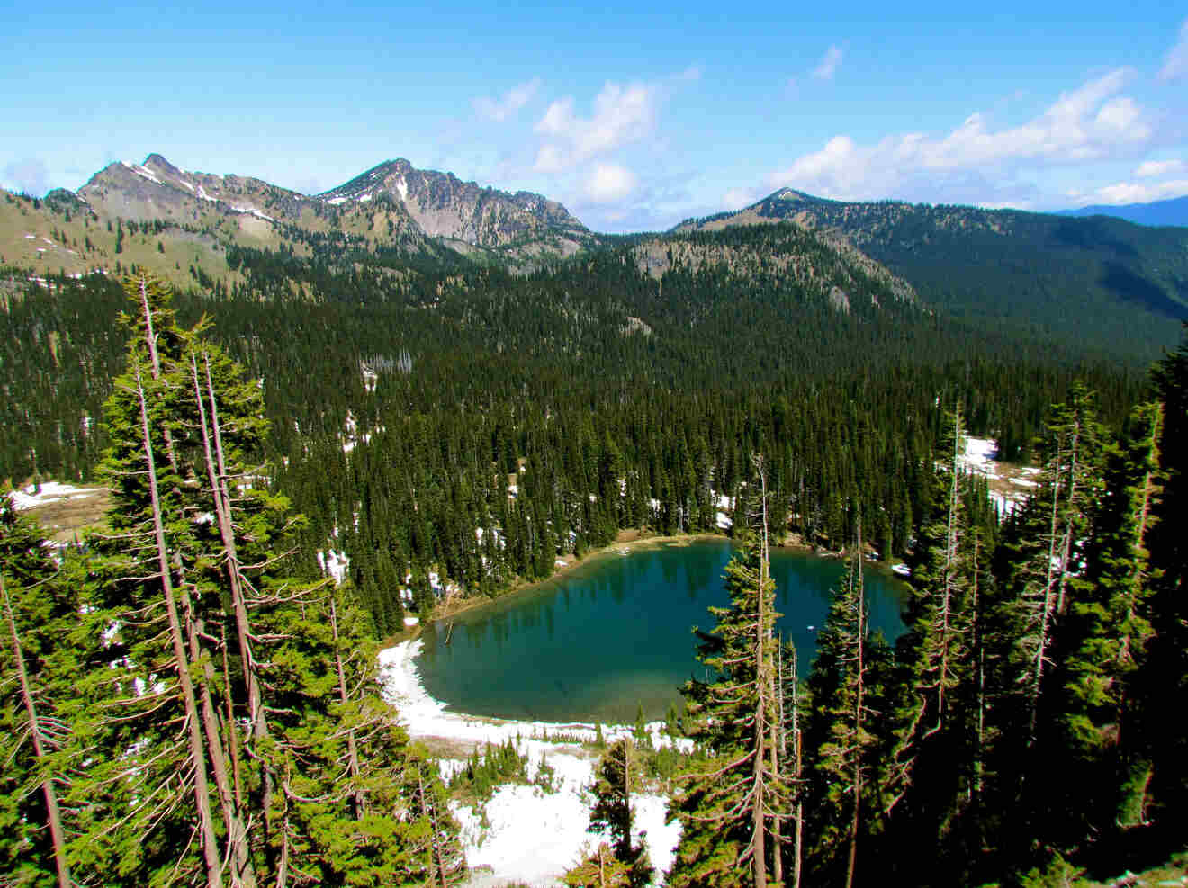 a lake surrounded by trees in the mountains