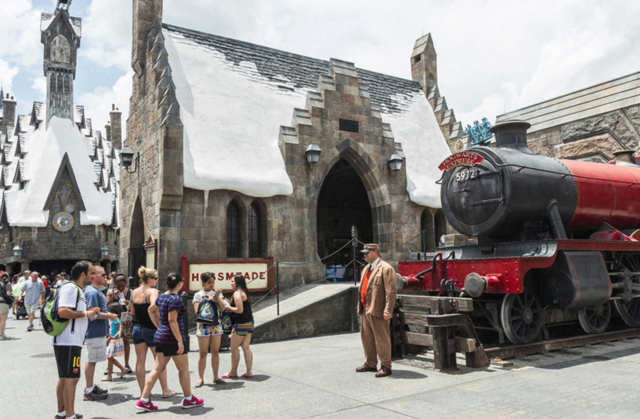 People standing in front of the Hogwards Express train