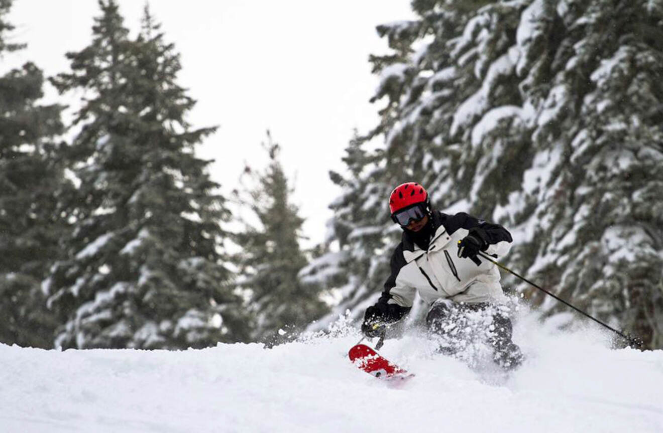 a man skiing down a snow covered slope