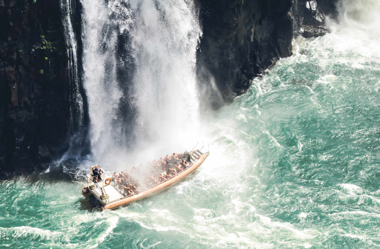 A boat with tourists under the Iguazu waterfalls