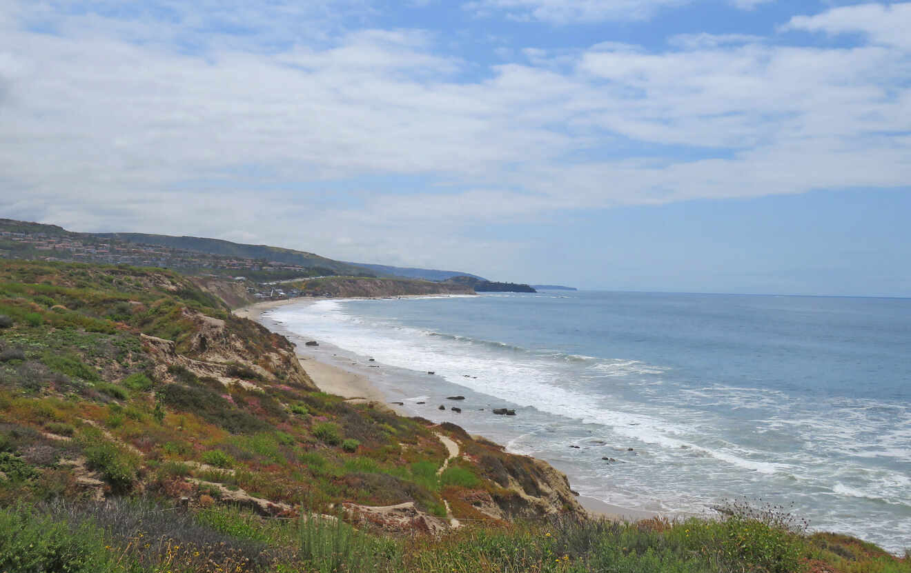 a view of the ocean from the top of a hill