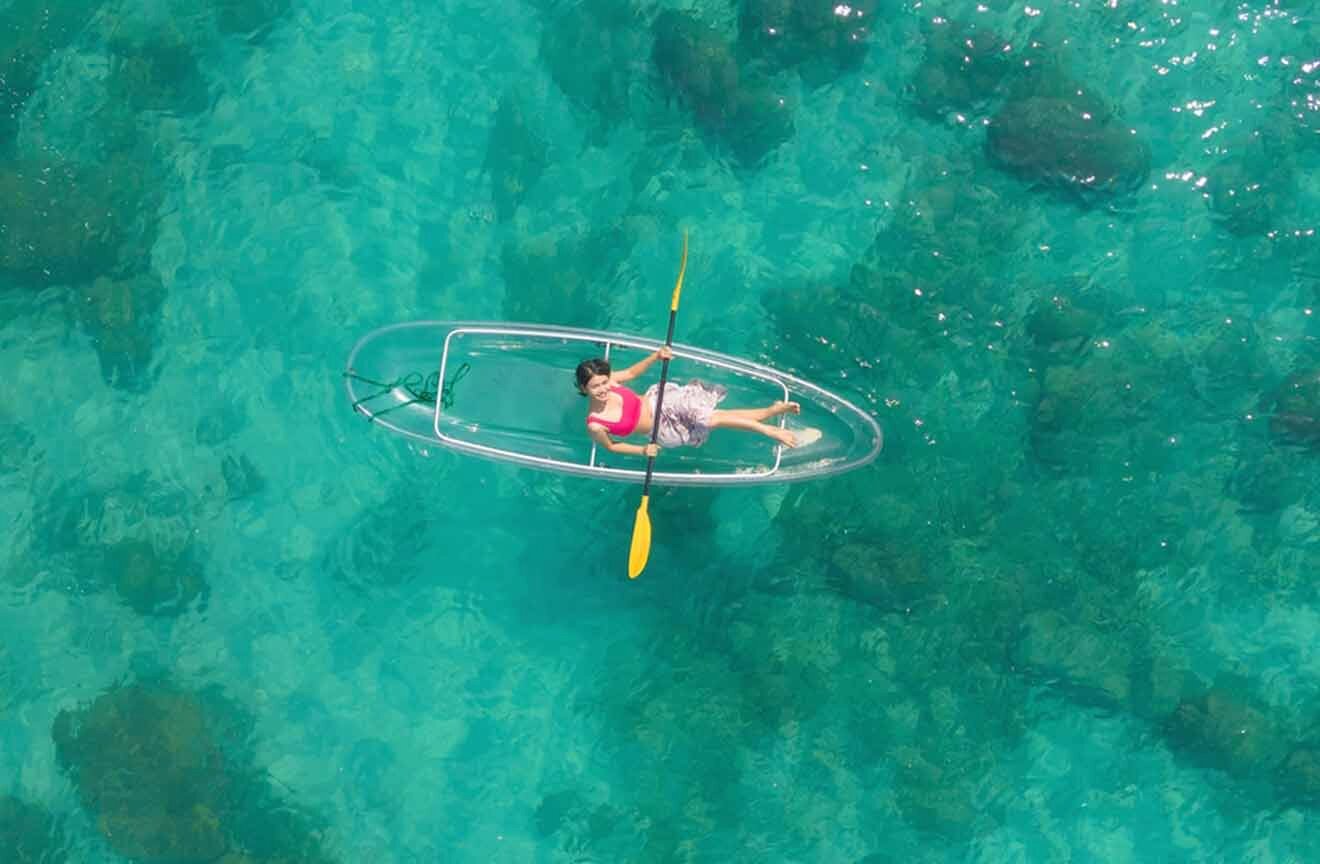 woman in a glass kayak in the water