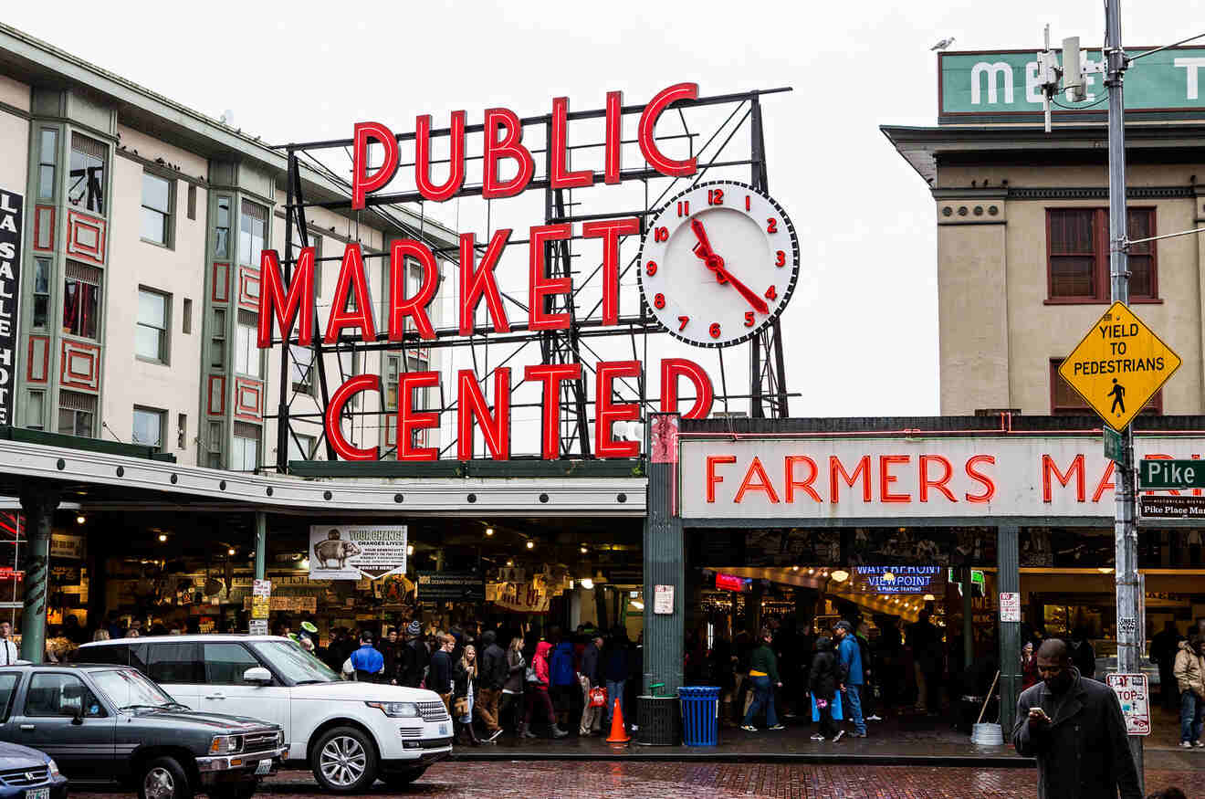 a group of people standing outside of a farmers market