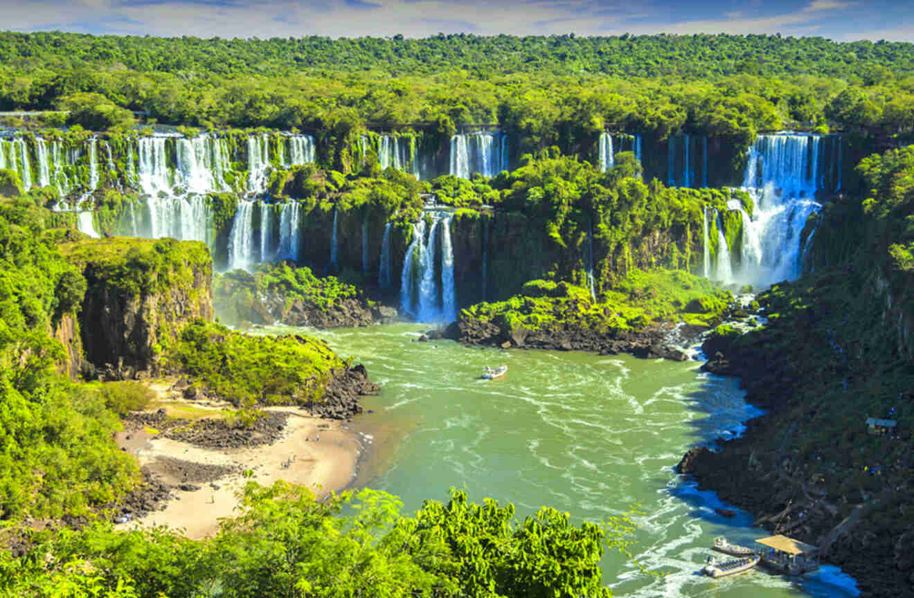 Aerial view of a large waterfall surrounded by lush green trees