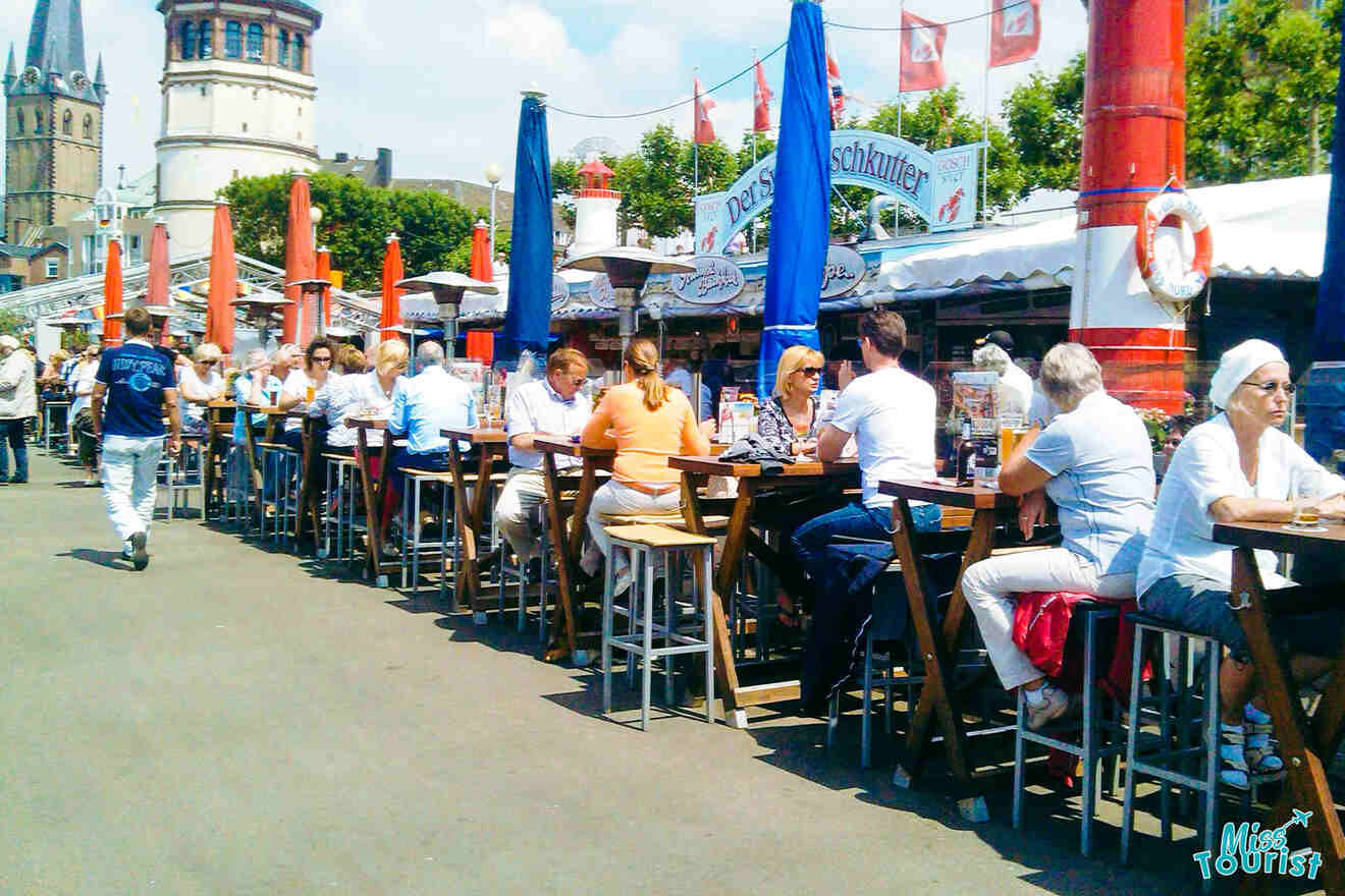 People drinking and eating outside a pub