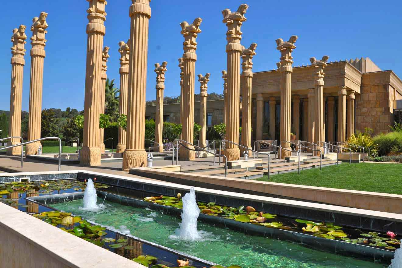 a large building with columns and a fountain in front of it