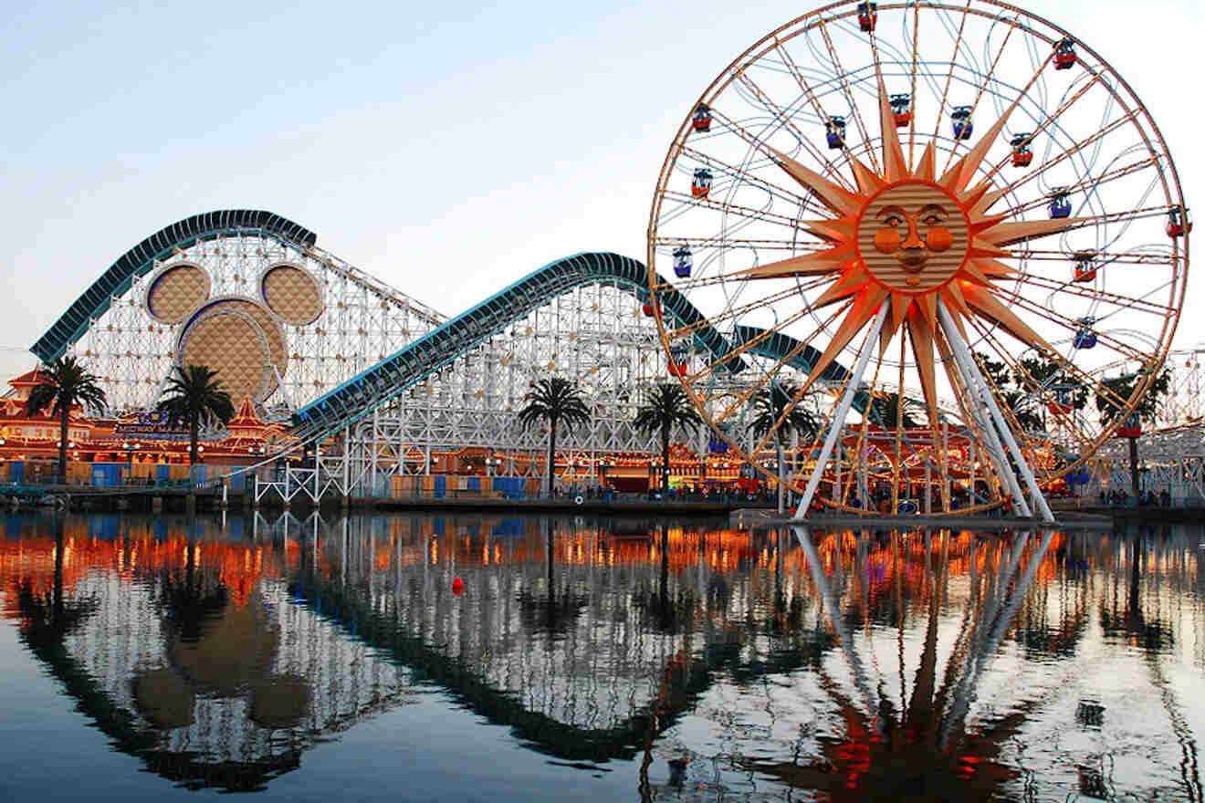 a ferris wheel next to a body of water with Disney California Adventure in the background