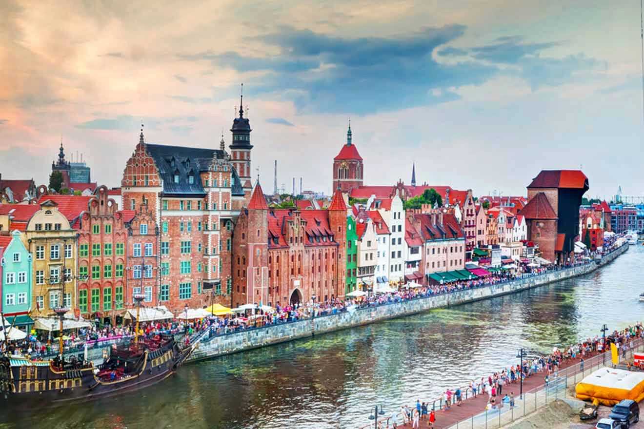 a lot of people standing on the river embankment in old town and the touristic ship