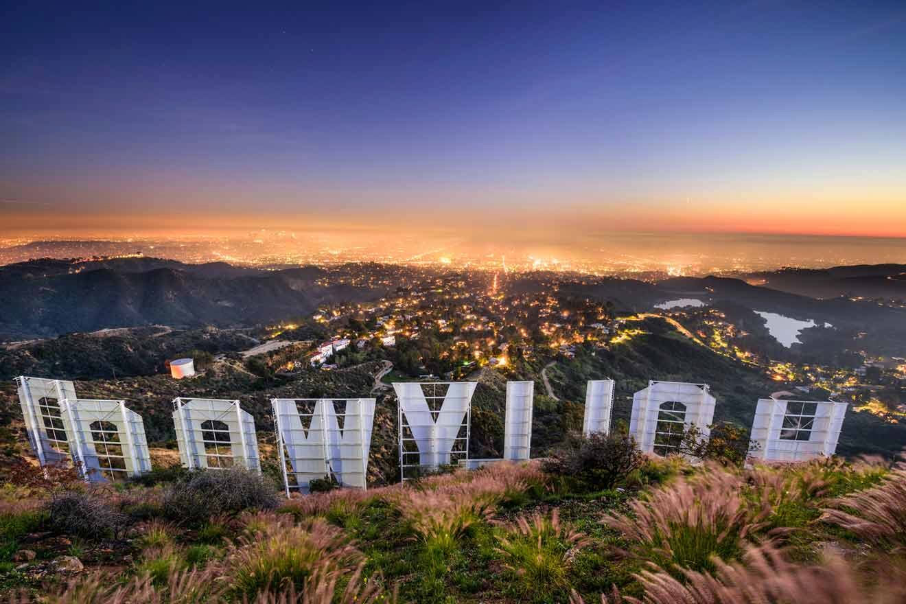 Hollywood sign view from behind overlooking the city at night