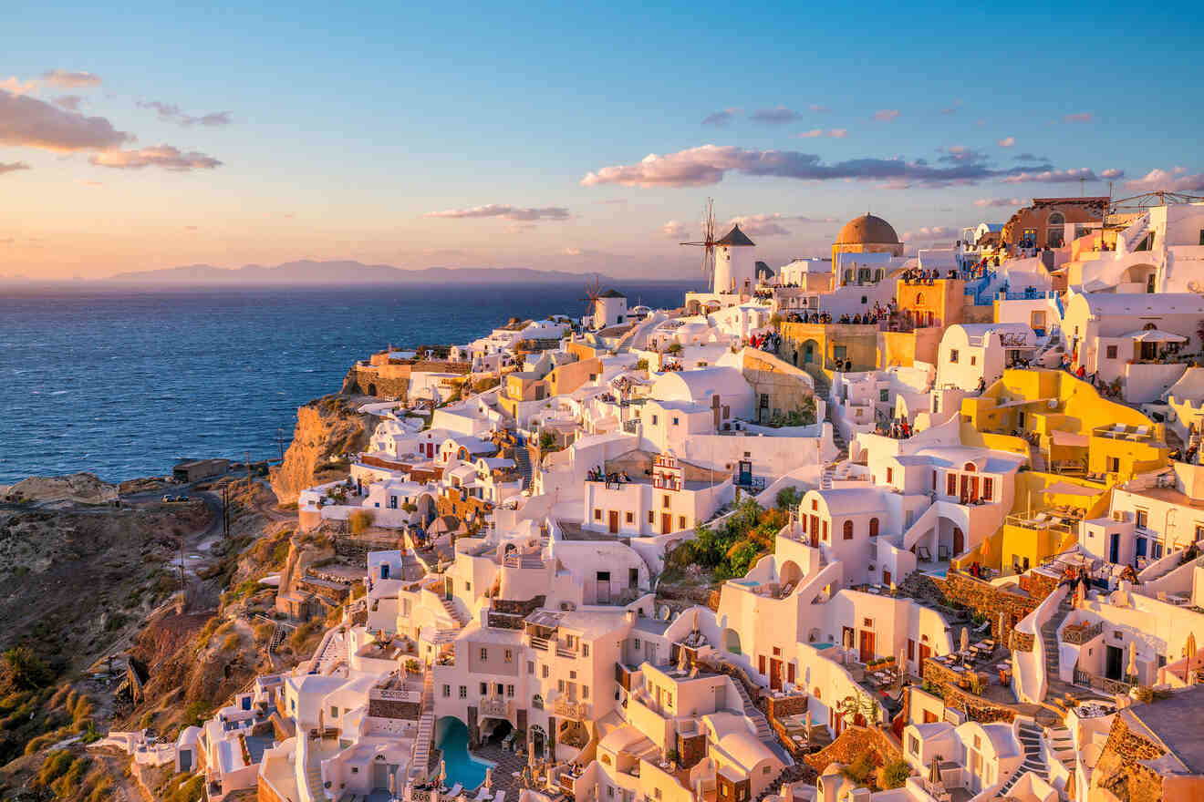 Golden hour illuminates the whitewashed houses and windmills of Oia, Santorini