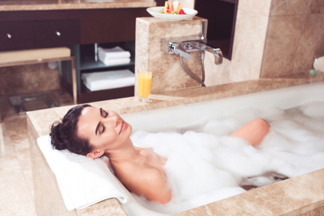 woman lying in a foamy bathtub