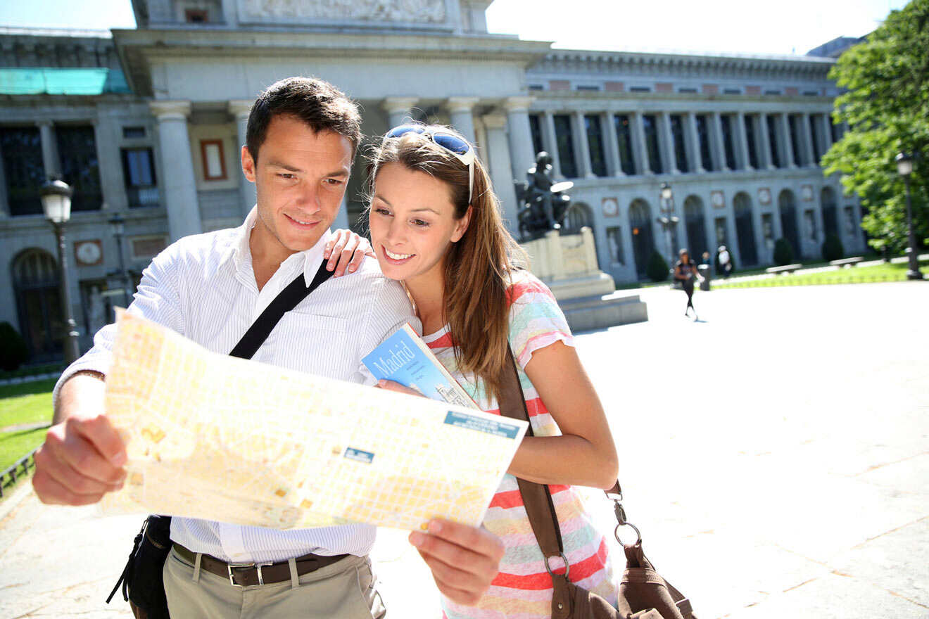 couple looking at the map in front of Prado Museum