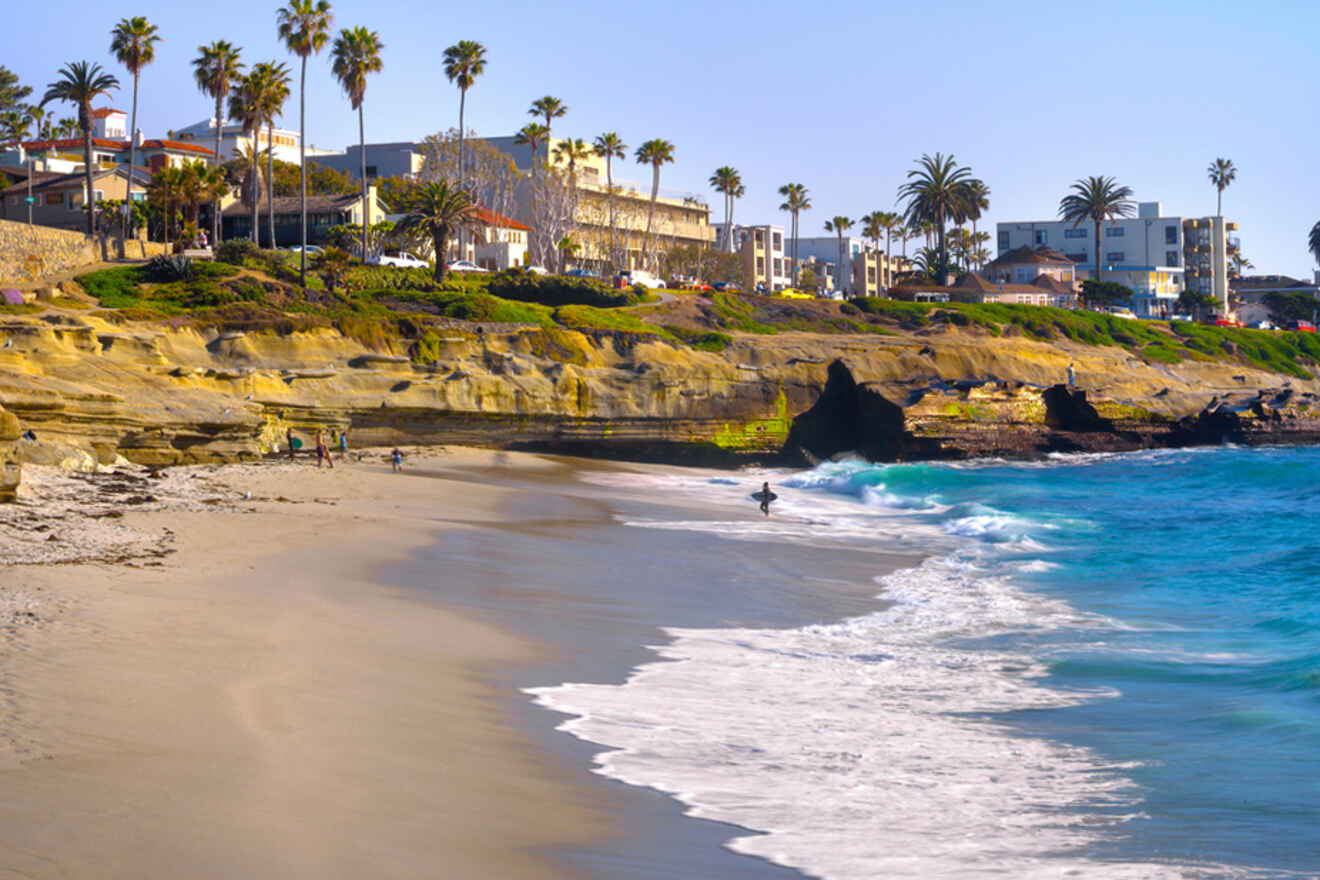 a beach with a few buildings on the background