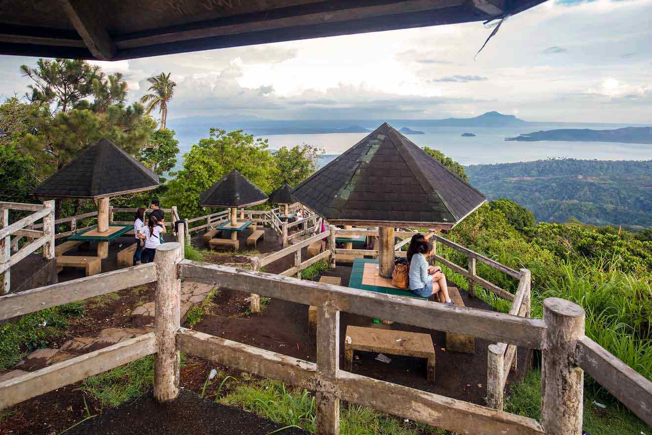 group of people sitting on wooden bench at the observation deck