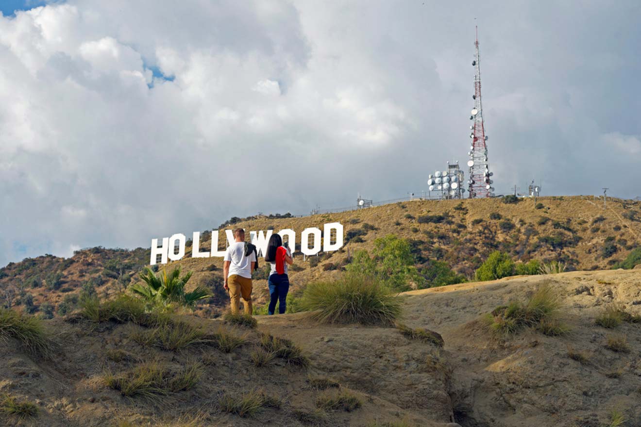 a group of people standing in front of a hollywood sign