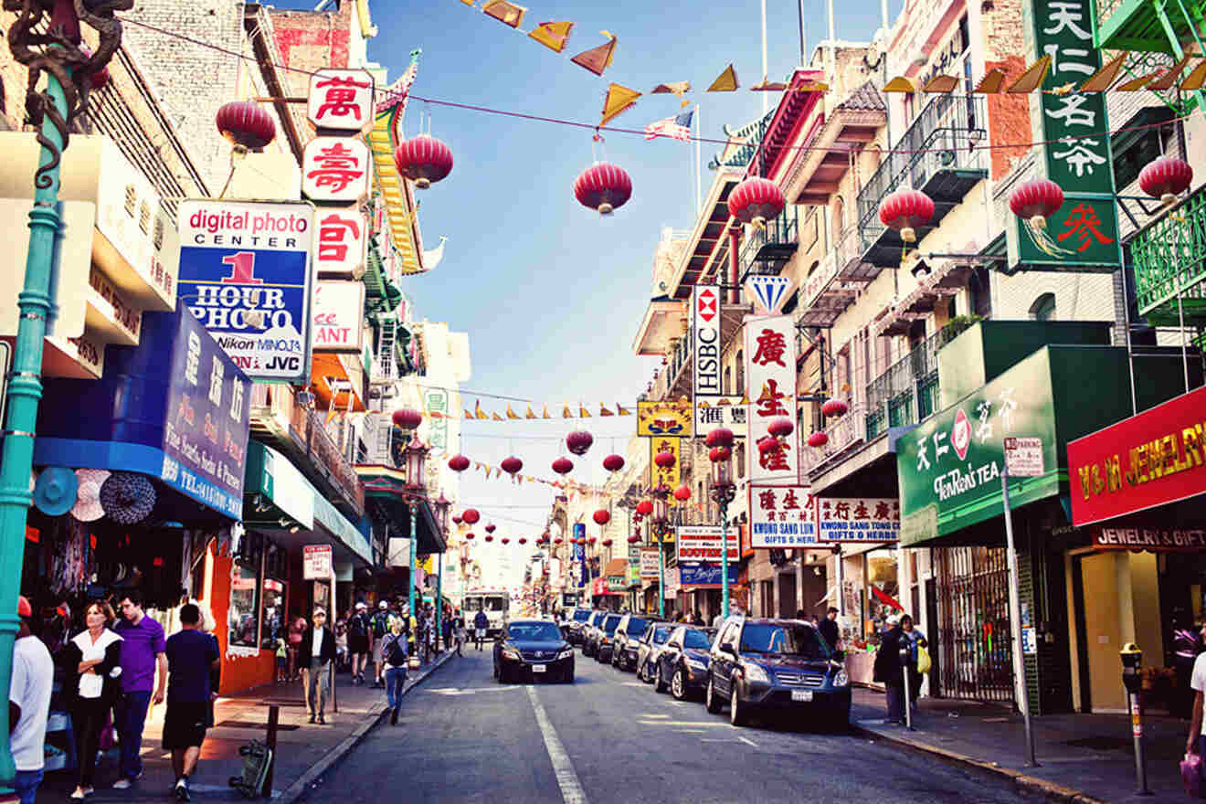 a city street filled with lots of tall buildings in Chinatown