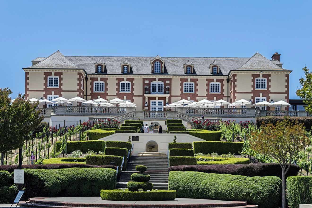 a large building with a lot of hedges in front of it